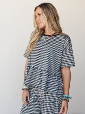 A relaxed gingham matching set styled with colorful beaded jewelry — the kind of outfit that looks effortless but clearly wasn't an accident.