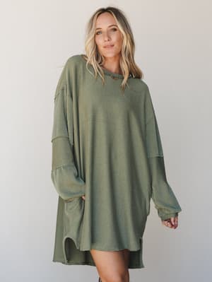 An oversized ribbed mini dress in washed army green worn with easy confidence — the kind of piece that looks like you tried just enough and felt great the whole time.