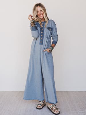 Woman wearing a blue denim outfit with a white background