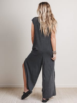 Back view of woman wearing a black and gray patterned jumpsuit