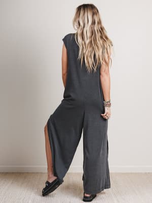Back view of woman wearing a black and gray patterned jumpsuit
