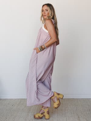 A breezy printed jumpsuit with wide legs and a relaxed drape styled with stacked beaded bracelets and mustard platform clogs — the kind of outfit that looks like you tried just enough.