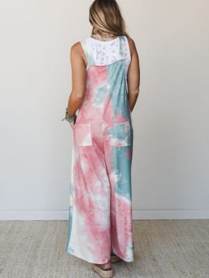 A wide-leg tie-dye overall in cotton-candy pink and seafoam green, shot from the back to show off the relaxed silhouette and lace-back layering detail — the kind of outfit that makes a Saturday feel intentional.
