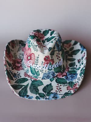 A floral tapestry cowgirl hat with 'sweetheart' embroidered across the front — the kind of hat that makes a whole outfit out of nothing.