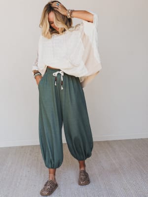 Relaxed harem-style joggers in a muted olive paired with an oversized cream top and leopard flats — the kind of outfit that looks effortless but was absolutely thought about.