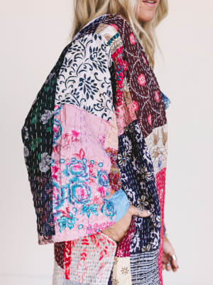 Woman wearing a colorful, One-of-a-Kind Stargazer Quilted Kimono in Multi against a plain background