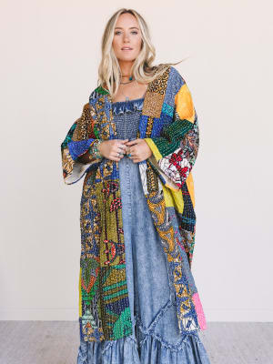 Woman wearing a colorful, One-of-a-Kind Stargazer Quilted Kimono in Multi over a denim dress on a plain background