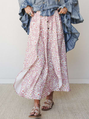 A flowy floral maxi skirt in dusty rose paired with a ruffled denim top and buckle sandals — the kind of outfit that looks effortless but was absolutely thought about.