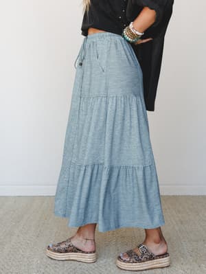 A heather teal tiered maxi skirt styled with a cropped black button-down and leopard print platform sandals — the kind of effortless, thrown-together outfit that somehow always looks intentional.