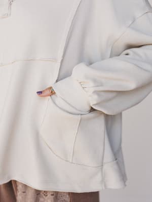 Close-up of a light gray jacket with a blurred background