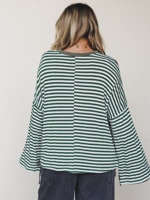A back-view shot of a relaxed striped bell sleeve top in forest green and white, paired with slate wide-leg pants — the kind of effortless combo that looks like you tried just enough.