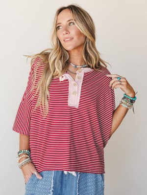A relaxed striped henley top in marsala and cream gets layered with stacked turquoise and beaded bracelets, distressed jeans, and a beaded choker — the kind of effortless mix that looks like you tried just enough.
