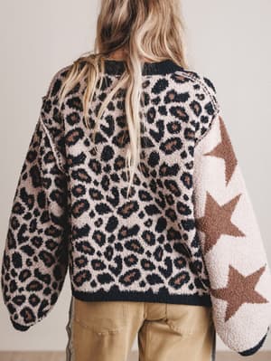 Person wearing a leopard print and star patterned jacket with beige pants.
