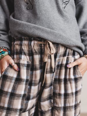 Plaid pants with a drawstring and gray sweater