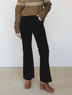 Dark chocolate velvet flare trousers styled with a cozy fair isle sweater and tan suede clogs — the kind of autumn outfit that feels intentional without trying too hard.