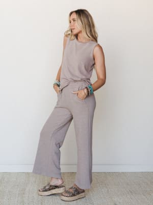 A mocha-toned matching set styled with stacked turquoise bracelets and platform espadrille sandals — the kind of effortless outfit that looks like you tried just enough.