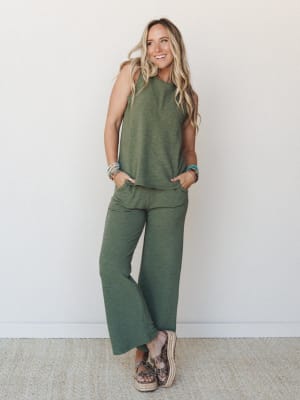 A matching olive tank and wide-leg pants set styled with platform espadrilles and stacked boho bracelets — the kind of effortless monochromatic look that somehow makes a Tuesday feel intentional.