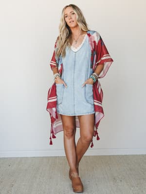 A relaxed, layered look built around a light wash denim mini dress and a flowing floral kimono in deep red — the kind of outfit that feels effortless on a warm afternoon but still looks like you tried.