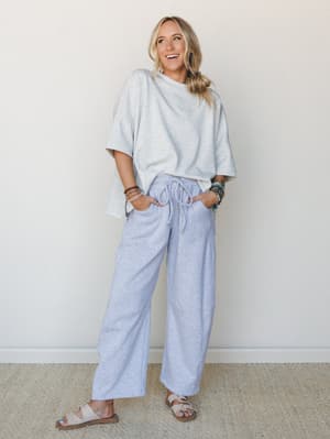 A relaxed, effortlessly cool set in heather gray — oversized boxy tee paired with wide-leg drawstring pants and layered bracelets that give the whole look a lived-in, off-duty energy.