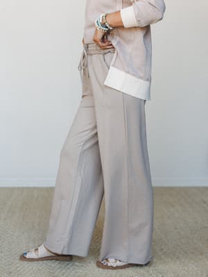 A relaxed, tonal set in warm sandy tones — wide-leg drawstring pants paired with a cuffed top feel like the outfit you reach for when you want to look put-together without thinking too hard about it.