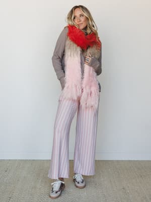 A playful, personality-forward look built around wide-leg striped pants and a fluffy ombre scarf — the kind of outfit that makes you smile before you even know why.