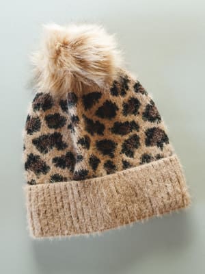 Tan leopard print beanie with a fluffy pom-pom on a light gray background
