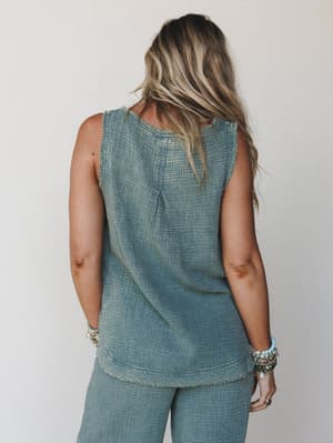 A back-view shot of a relaxed sleeveless tank in a washed ash jade gauze, paired with matching wide-leg pants and layered boho bracelets — the kind of effortless two-piece moment that looks like it just happened.