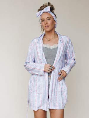 A matching floral-stripe robe and bow headband set styled over a gray lace-trim cami, worn with stacked silver and turquoise rings — the kind of morning look that makes getting out of bed feel optional.