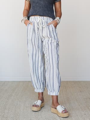 Relaxed striped pants in cream and navy styled with a washed crop tee and platform espadrille slides — the kind of effortless outfit that looks like you tried just enough.