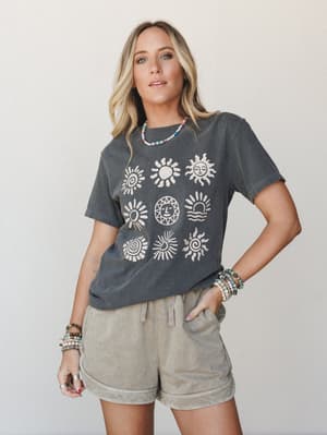 A washed charcoal graphic tee printed with nine illustrated sun motifs pairs with stone-washed drawstring shorts, layered beaded jewelry finishing off a look that feels like a farmers market Saturday with nowhere to be.
