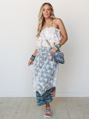 A layered boho look built on sheer lace and soft florals — the kind of outfit that feels equally at home wandering a weekend market or dancing at an outdoor wedding.