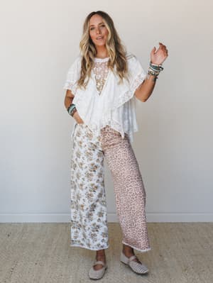 A breezy, mix-print two-piece set styled with stacked beaded bracelets and woven flats — the kind of outfit that looks like you put it together effortlessly but definitely did not.