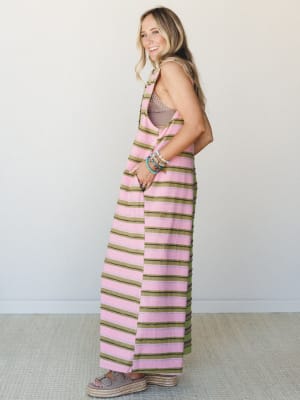 A striped wide-leg jumpsuit in pink and olive worn over a taupe bralette, styled with stacked beaded bracelets and espadrille platform sandals — the kind of outfit that looks effortless but clearly had a whole vibe in mind.