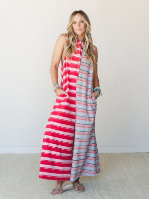 A breezy color-blocked maxi jumpsuit in bold red and soft grey stripes worn with flat sandals and stacked turquoise bracelets — effortless and a little unexpected, like your most fun summer outfit that also has pockets.