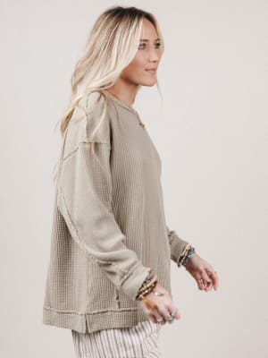 Woman wearing a beige jacket with a neutral background