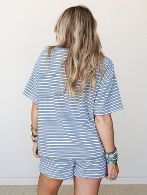 Shot from behind, this matching striped set — an oversized tee and mini shorts — has that easy, thrown-on-right energy, styled with stacks of boho bracelets that do all the personality-talking.