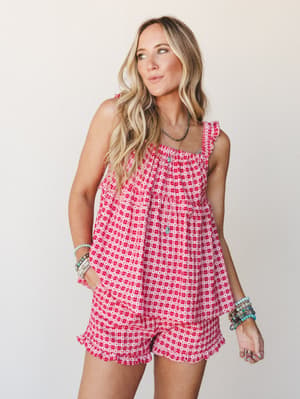 A red and white gingham-print matching set with tiny heart details — the kind of outfit that makes a Saturday feel intentional, styled with stacked turquoise bracelets and a delicate layered necklace.