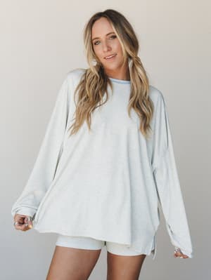 An oversized ribbed long sleeve top in soft baby blue stripe is paired with matching biker shorts — the kind of effortless matching set that blurs the line between 'just got cozy' and 'totally put together.'
