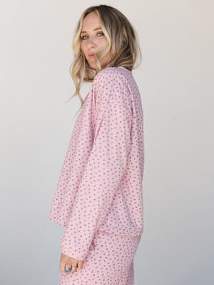 A matching floral ribbed set in soft pink — the kind of outfit that blurs the line between staying in and going out, styled with stacked turquoise rings for a little personality.
