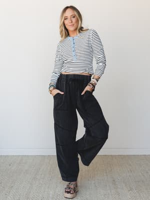 A striped crop henley top paired with wide-leg black cargo pants and espadrille sandals — the kind of effortless, put-together combo that makes a Tuesday feel intentional.