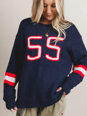 Navy sweater with red and white accents worn by a person