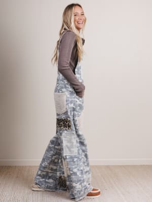 Woman wearing a long, patterned dress with a plain background