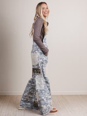 Woman wearing a long, patterned dress with a plain background
