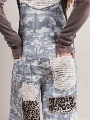 Person wearing a patterned outfit with leopard print accents on a neutral background