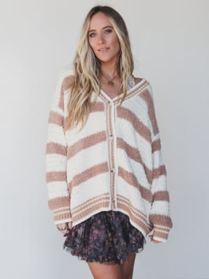 Woman wearing a striped sweater against a plain background