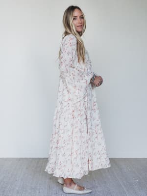 Woman wearing a floral dress against a white background