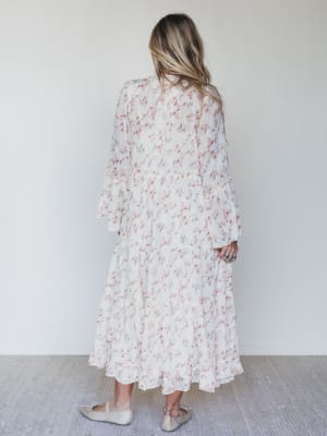 Woman wearing a floral dress against a white background