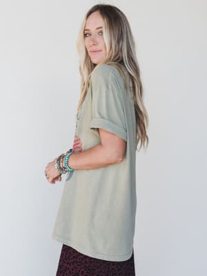 Woman wearing a light green t-shirt with a white background