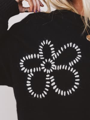 Black sweater with white geometric pattern on the back