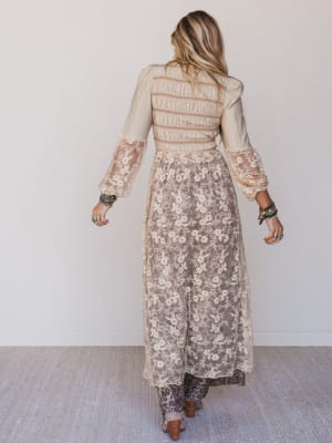 Woman wearing a floral dress with a plain background